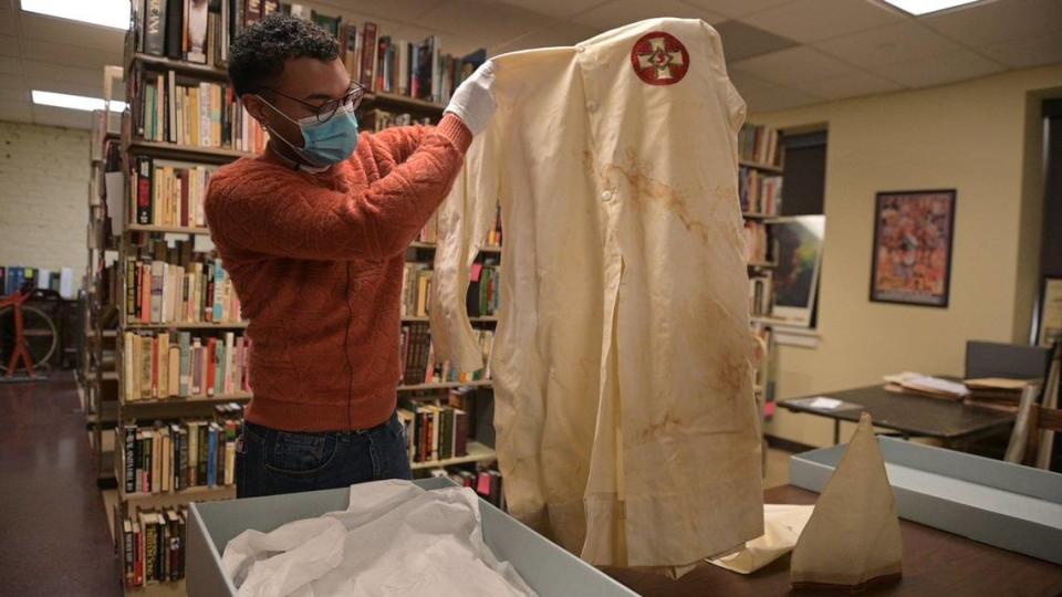 Digital archivist Nic Gibson shows the Ku Klux Klan robes kept in storage at the Black Archives of Mid-America.