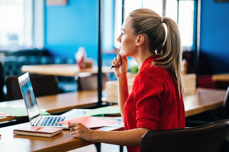 woman at laptop, thinking