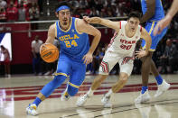 UCLA guard Jaime Jaquez Jr. (24) drives as Utah guard Lazar Stefanovic (20) defends during the first half of an NCAA college basketball game Thursday, Jan. 20, 2022, in Salt Lake City. (AP Photo/Rick Bowmer)