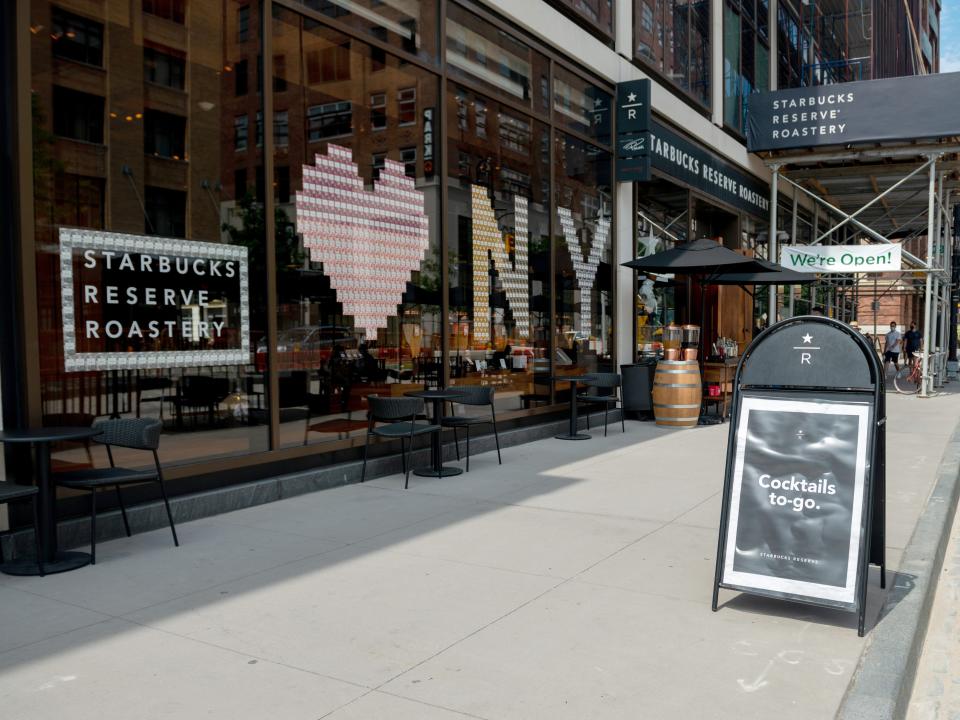 A cocktails to-go sign is seen outside the Starbucks Reserve Roastery in Chelsea as the city continues Phase 4 of re-opening following restrictions imposed to slow the spread of coronavirus on July 30, 2020 in New York City.