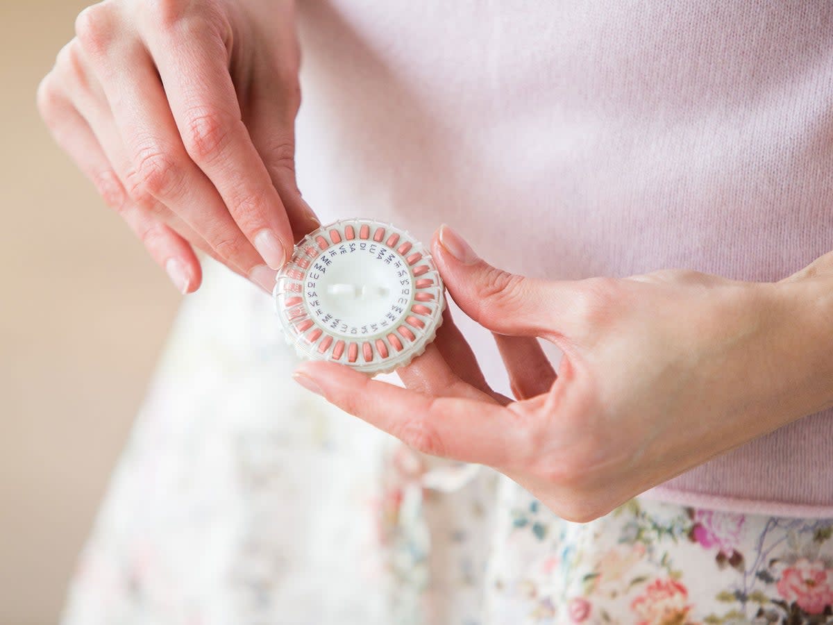 Woman taking an hormone replacement therapy pills. (Shutterstock)