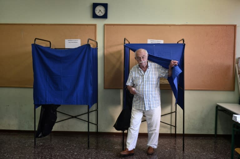 A man emerges from a polling booth in Athens after voting in the Greek bailout referendum on July 5, 2015