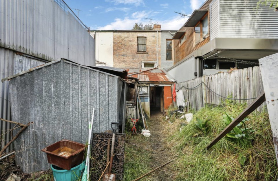 Overgrown grass is seen in the backyard of a Waterloo home in Sydney.