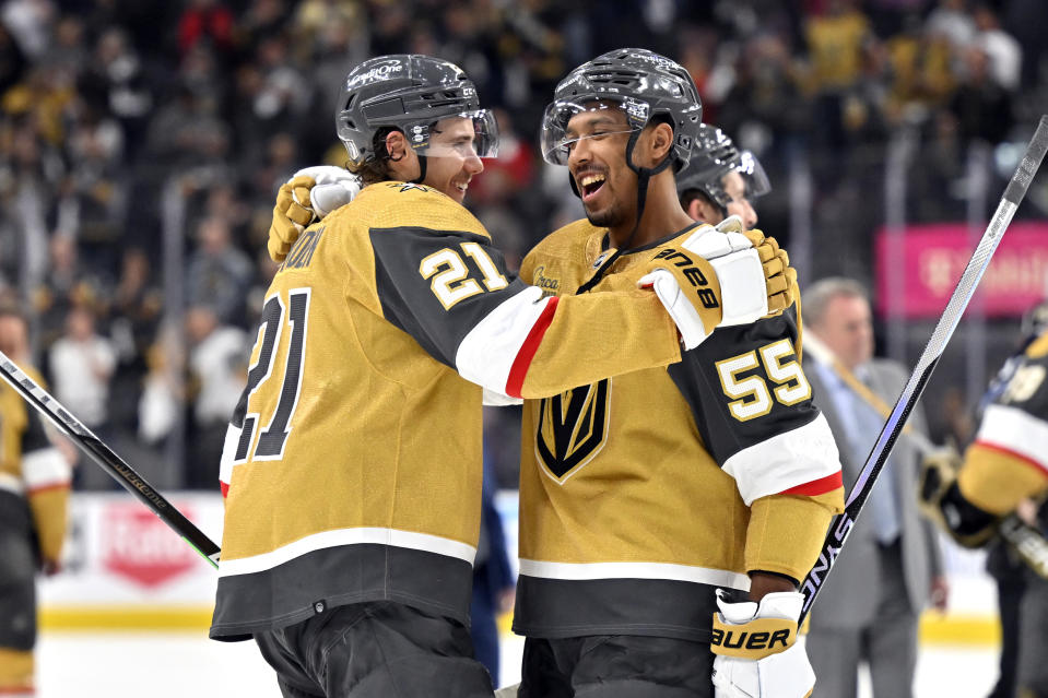 Vegas Golden Knights center Brett Howden (21) and right wing Keegan Kolesar (55) celebrate the team's 4-1 win over the Winnipeg Jets in Game 5 of an NHL hockey Stanley Cup first-round playoff series Thursday, April 27, 2023, in Las Vegas. The Golden Knights won the series. (AP Photo/David Becker)