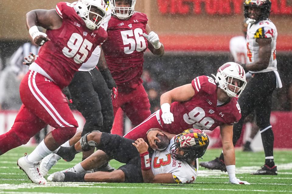 Wisconsin defensive end Isaiah Mullens (99) sacks Maryland quarterback Taulia Tagovailoa (3) during the first half of an NCAA college football game Saturday, Nov. 5, 2022, in Madison, Wis. (AP Photo/Andy Manis)