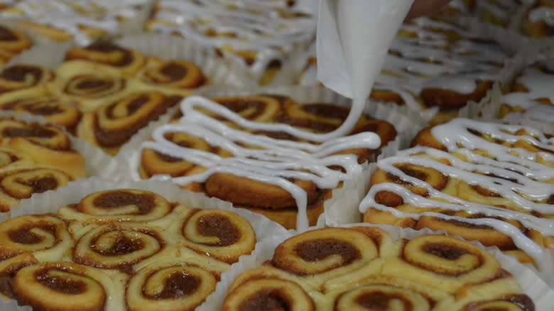 chick-fil-a cinnamon clusters being drizzled with frosting