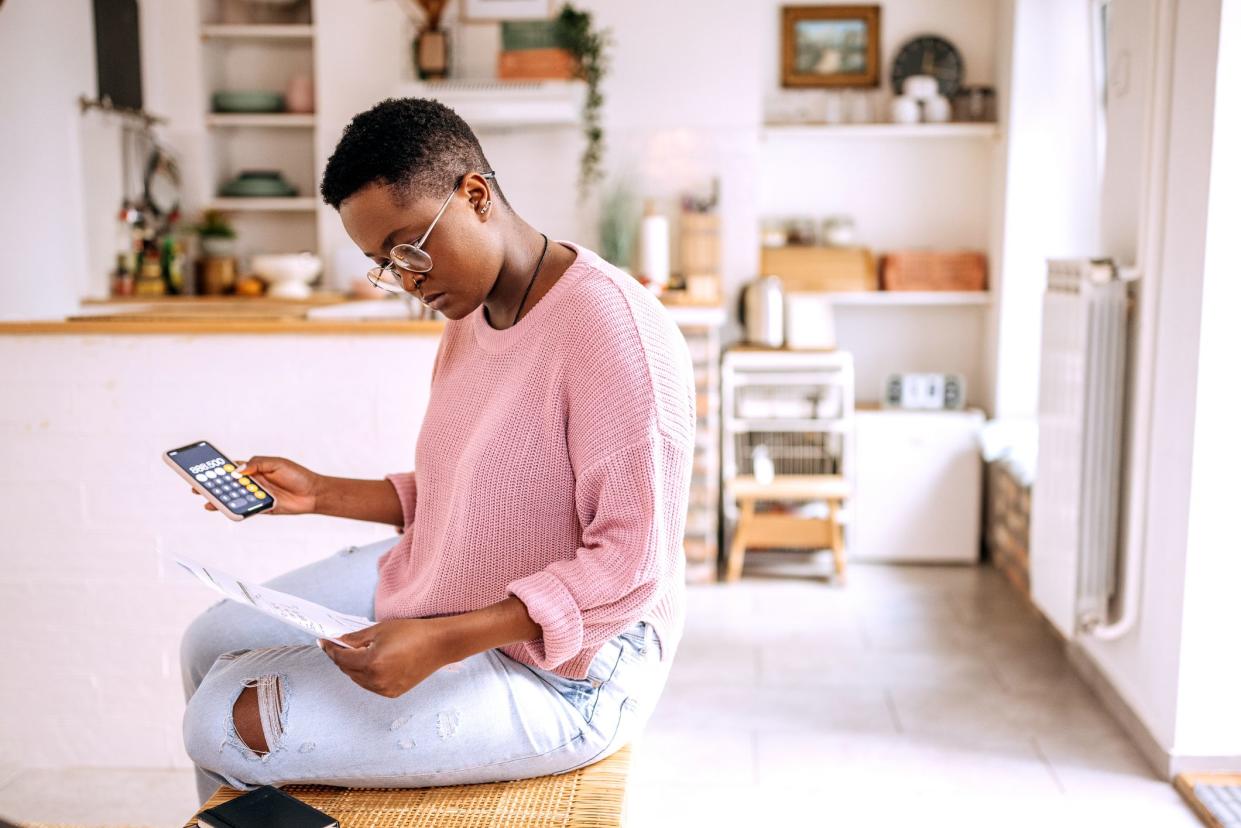 Young beautiful woman going over finances at home
