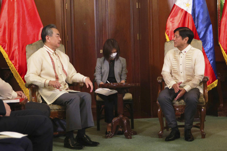 In this handout photo provided by the Malacanang Presidential Photographers Division, Philippine President Ferdinand Marcos Jr., right, talks with Chinese Foreign Minister Wang Yi during a courtesy call at the Malacanang Presidential Palace in Manila, Philippines on Wednesday, July 6, 2022. (Malacanang Presidential Photographers Division via AP)