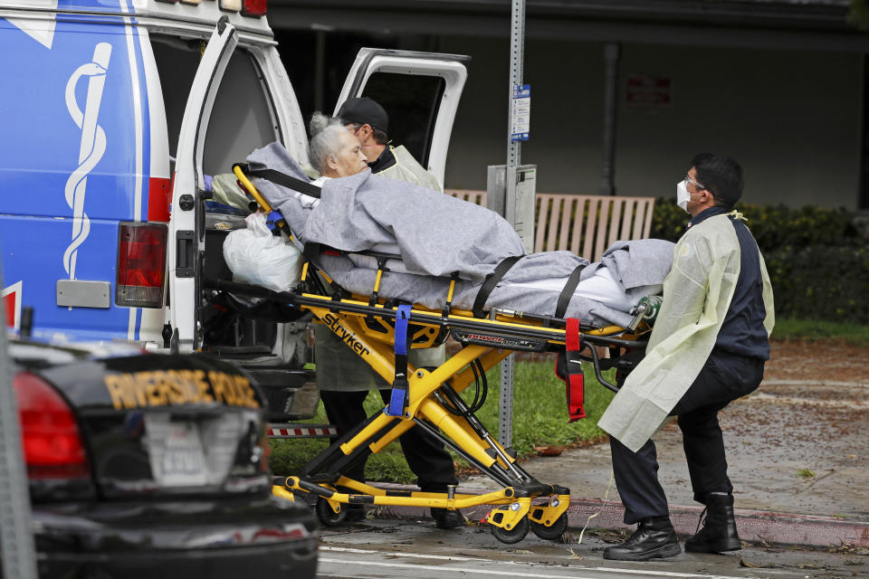 FILE - In this April 8, 2020 file photo, a patient at the Magnolia Rehabilitation and Nursing Center in Riverside, Calif., is evacuated to a waiting ambulance. Officials in Riverside County have filed a complaint over conditions at the skilled nursing facility that was evacuated after staff failed to show up for work during a coronavirus outbreak. Dr. Cameron Kaiser, the county's public health officer, sent a letter asking state health officials for an assessment of Magnolia Rehabilitation and Nursing Center before the facility reopens. (AP Photo/Chris Carlson, File)