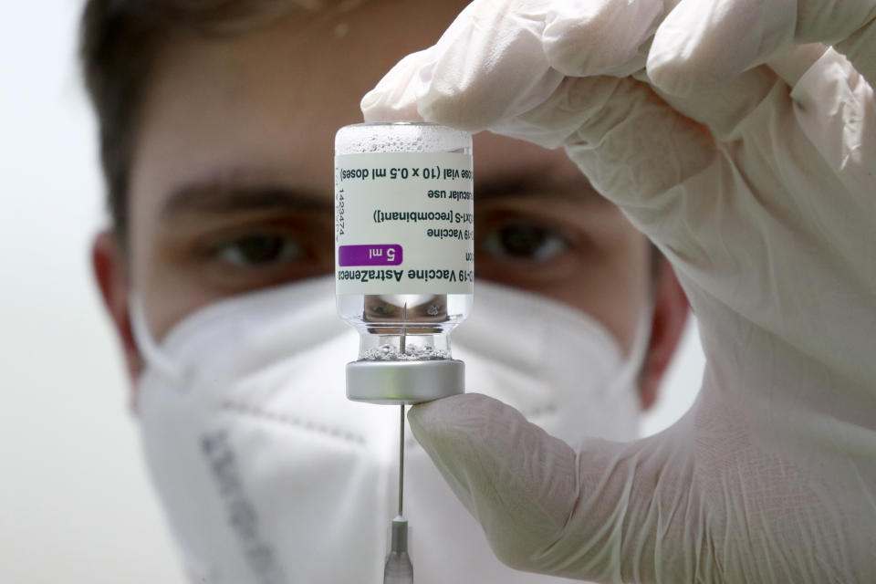 FILE - In this file photo dated Monday, March 22, 2021, medical staff prepares a syringe from a vial of the AstraZeneca coronavirus vaccine during preparations at the vaccine center in Ebersberg near Munich, Germany. Berlin’s top health official said Tuesday March 30, 2021, that the German state of Berlin is again suspending the use of AstraZeneca’s coronavirus vaccine for people under 60 as a precaution, due to reports of blood clots. (AP Photo/Matthias Schrader, FILE)