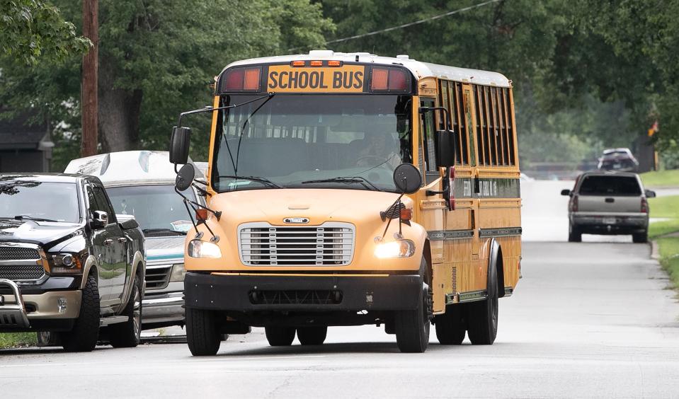A JCPS bus drives down Strader Avenue on the way from the bus compound on Thursday, August 10, 2023  School bus drivers worked on their routes after a difficult first day of classes.