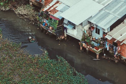 <span class="caption">Houses alongside the Saigon river in Vietnam.</span> <span class="attribution"><a class="link " href="https://unsplash.com/photos/fAYHQEopGPA" rel="nofollow noopener" target="_blank" data-ylk="slk:Tony La Hoang/Unsplash;elm:context_link;itc:0;sec:content-canvas">Tony La Hoang/Unsplash</a>, <a class="link " href="http://creativecommons.org/licenses/by-sa/4.0/" rel="nofollow noopener" target="_blank" data-ylk="slk:CC BY-SA;elm:context_link;itc:0;sec:content-canvas">CC BY-SA</a></span>