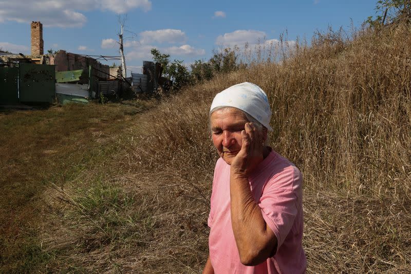 Vira Chernukha at her damaged house in the village of Dementiivka in Kharkiv region