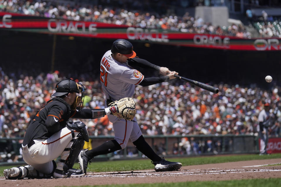 Baltimore Orioles' Austin Hays (21) hits an RBI-single in front of San Francisco Giants catcher Patrick Bailey, left, during the third inning of a baseball game in San Francisco, Sunday, June 4, 2023. (AP Photo/Jeff Chiu)