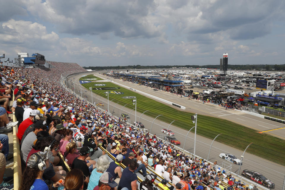 Fans watch a NASCAR Cup Series auto race at Michigan International Speedway in Brooklyn, Mich., Sunday, Aug. 12, 2018. (AP Photo/Paul Sancya)