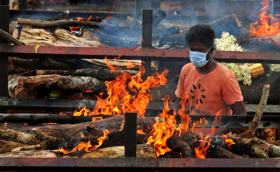 Funeral pyres for Covid-19 victims burn during a mass funeral at a makeshift cremation ground at Giddenahalli in the outskirts of Bangalore, India.