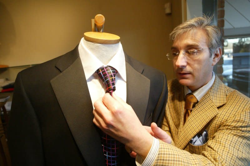 Salesman Michael Nobel adjusts a colorful tie on a tuxedo display in the window at Mister Guy Clothier in Ladue, Mo., on November 25, 2005. On October 10, 1886, Griswold Lorillard of Tuxedo Park, N.Y., fashioned the first tuxedo for men. File Photo by Bill Greenblatt/UPI