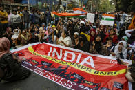 Indians block a road as they participate in a rally to protest against a new citizenship law, in Kolkata, India, Tuesday, Jan. 21, 2020. India has been embroiled in protests since December, when Parliament passed a bill amending the country's citizenship law. The new law provides a fast track to naturalization for some migrants who entered the country illegally while fleeing religious persecution. But it excludes Muslims, which critics say is discriminatory and a violation of India's Constitution. (AP Photo/Bikas Das)
