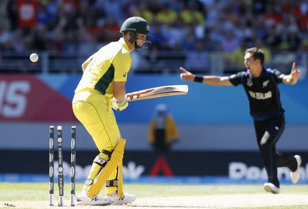 Australia's Shaun Marsh is bowled out by by New Zealand's Trent Boult (R) during their Cricket World Cup match in Auckland, February 28, 2015. REUTERS/Nigel Marple