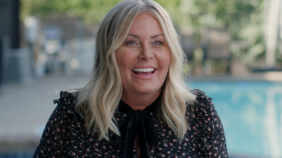 Nicole Eggert laughs and smiles as she sits poolside during an interview for After Baywatch: Moment in the Sun.