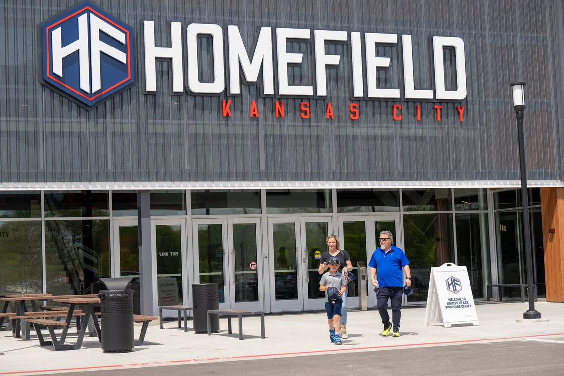 Rader Raboin, 8, of Olathe, his mother, Ali Raboin, and his grandfather Chuck Lawrence leave Homefield Kansas City after a ribbon cutting ceremony and tour Tuesday.