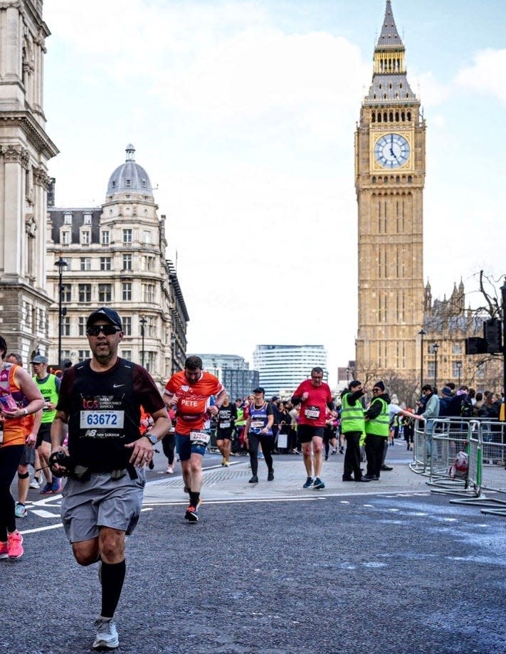 Apollo Lirio runs in the London Marathon with Big Ben in the background.