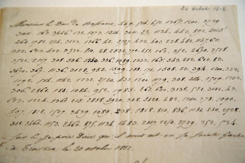 In this photo taken Wednesday, Nov. 28, 2012, a letter dictated by Napoleon in secret code that declares his intentions "to blow up the Kremlin" during his ill-fated Russian campaign is displayed in Fontainebleau, outside Paris. The rare letter, written in unusually emotive language, sees Napoleon complain of harsh conditions and the shortcomings of his grand army. The letter goes on auction Sunday, Dec. 2, 2012. (AP Photo/Christophe Ena)