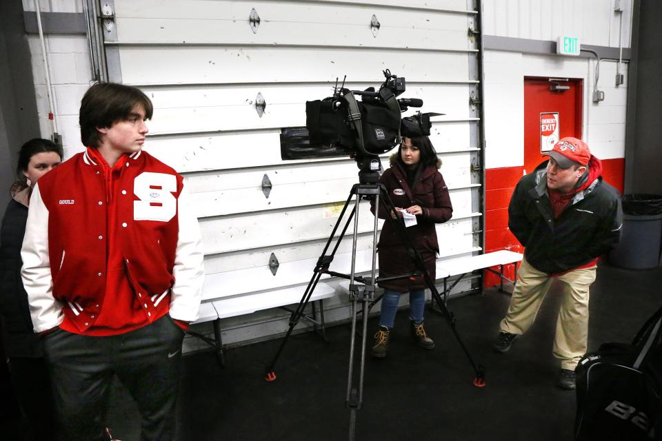 Spaulding High School athletic trainer Jon Mousette tries to get the attention of junior Matt Gould before being interviewed prior to Wednesday's Division II boys hockey game.