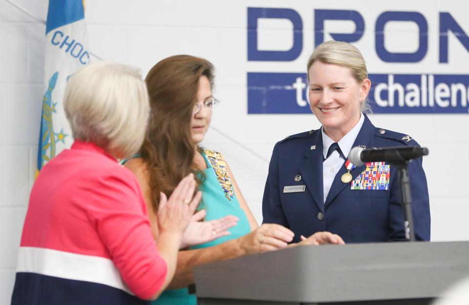 Col. Jocelyn Schermerhorn, commander of the 1st Special Operations Wing at Hurlburt Field, smiles after being presented with the Women In American History Medal by National Society of the Daughters of the American Revolution Honorary Chapter Regent Linda McCooey (center) in a ceremony at the HSU Innovation Institute in Fort Walton Beach.