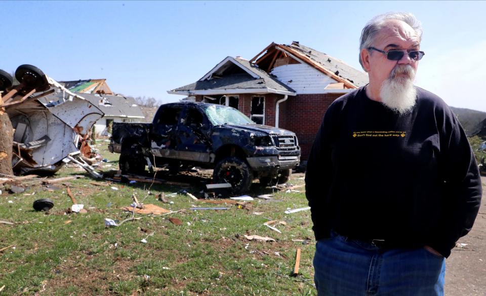 Buck Owen stands in front of his home on Readyville Street on Saturday, April 1, 2023, after an early morning storm damaged his home and vehicles waiting on a family member to arrive, in the Readyville, Tenn., community. 