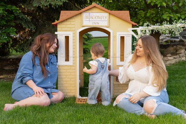 <p>Courtesy of Brittney Gage</p> Brittney Gage and her sister-in-law Hope Bayes watching Gage's daughter Hazel play with her Gilmore Girls-themed playhouse