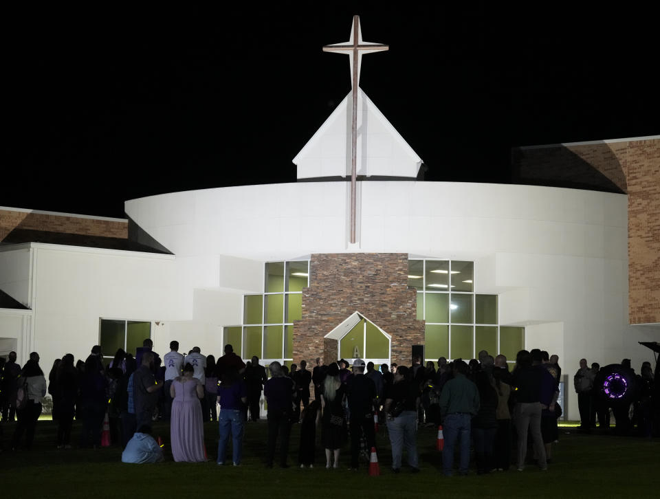 People gather on the lawn with glow sticks to send off Audrii Cunningham following a public visitation Friday, March 1, 2024, at First Baptist Church in Livingston, Texas. Audrii's body was found on the banks of the Trinity River, Feb. 20. (Yi-Chin Lee/Houston Chronicle via AP)