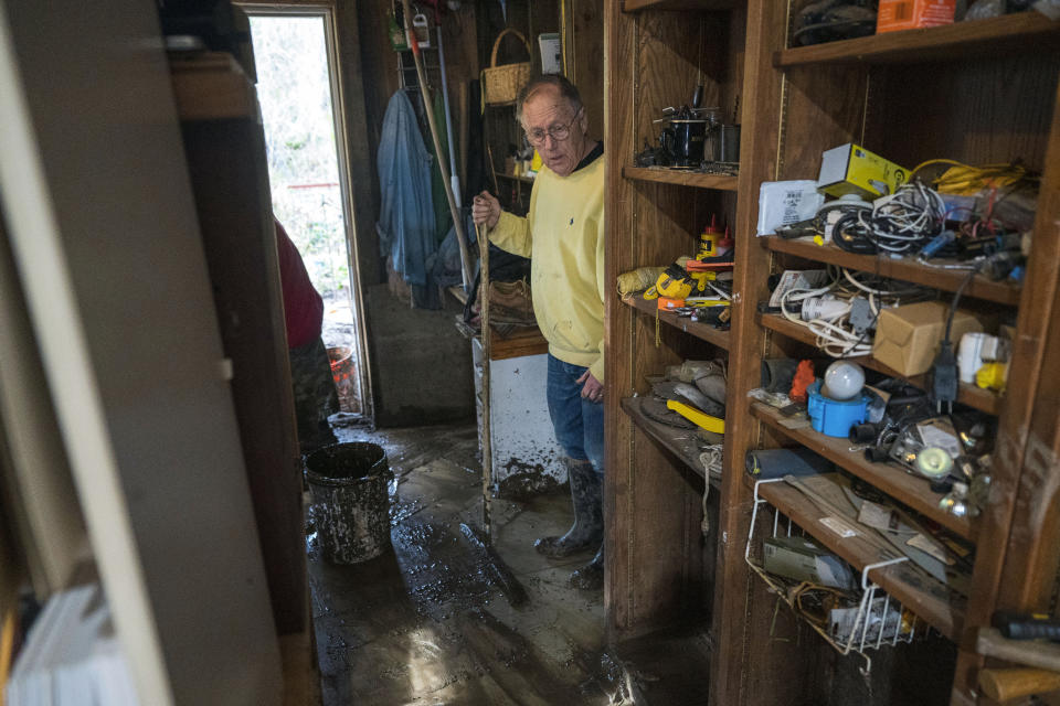 Howard Burman looks at mud that washed through his garage after the San Lorenzo River overflowed in the Felton Grove neighborhood of Felton, Calif., Tuesday, Jan. 10, 2023. The series of storms that have struck California have poured water on a state mired in a years-long drought. Experts say the precipitation will help relieve the drought somewhat. (AP Photo/Nic Coury)