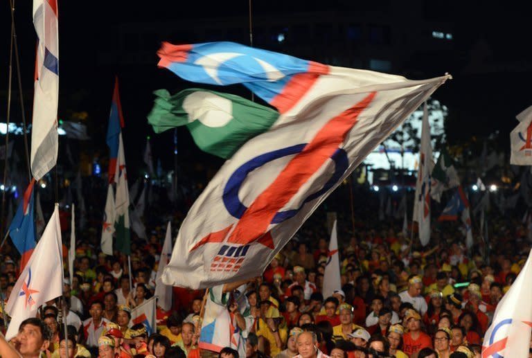 Supporters wave various opposition coalition party flags at a huge opposition rally in Penang, Malaysia on May 3, 2013. Anwar said only fraud can stop his Malaysian opposition from scoring a historic election win as the rival sides launched a last-ditch campaign blitz Saturday on the eve of a tense vote