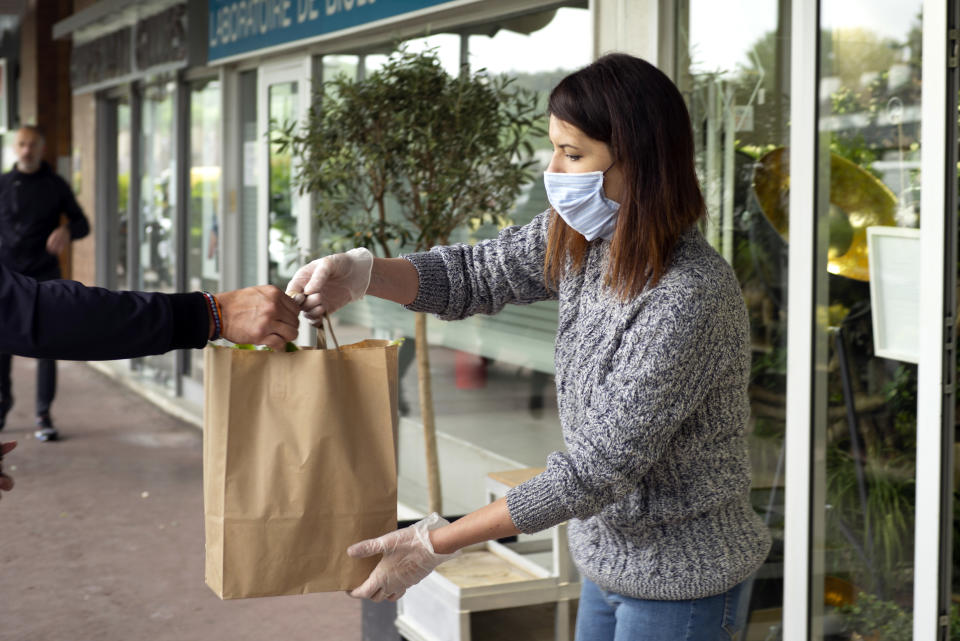 PARIS, FRANCE - MAY 01: A customer is seen picking up his Lily of the Valley after ordering online in celebration of Labor Day during the Coronavirus (COVID-19) pandemic on May 01, 2020 in La Celle Saint Cloud, France. The Coronavirus (COVID-19) pandemic has spread to many countries across the world, claiming over 233,000 lives and infecting over 3,26 million people. (Photo by Aurelien Meunier/Getty Images)