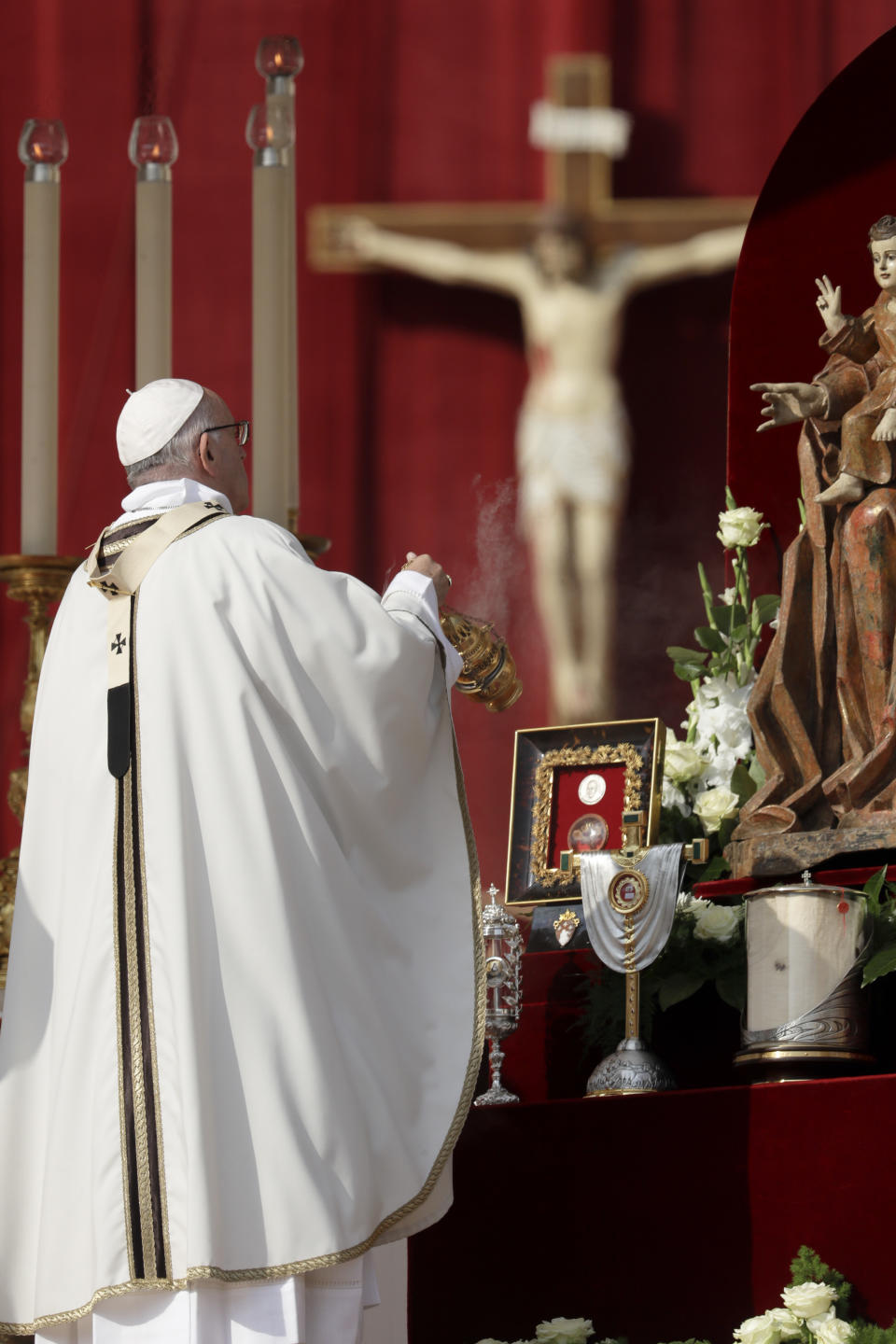 Pope Francis asperses incenses the relics during a canonization ceremony in St. Peter's Square at the Vatican, Sunday, Oct. 14, 2018. Pope Francis canonizes two of the most important and contested figures of the 20th-century Catholic Church, declaring Pope Paul VI and the martyred Salvadoran Archbishop Oscar Romero as models of saintliness for the faithful today. (AP Photo/Andrew Medichini)