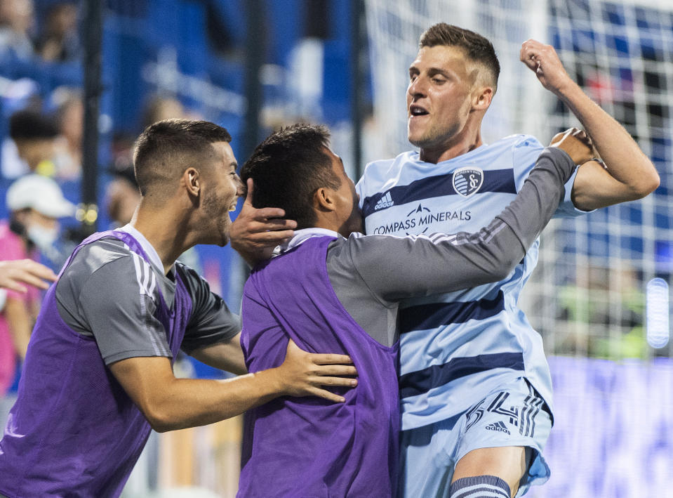 Sporting Kansas City's Remi Walter (54) celebrates with teammates after scoring against CF Montreal during the second half of an MLS soccer match Saturday, July 9, 2022, in Montreal. (Graham Hughes/The Canadian Press via AP)