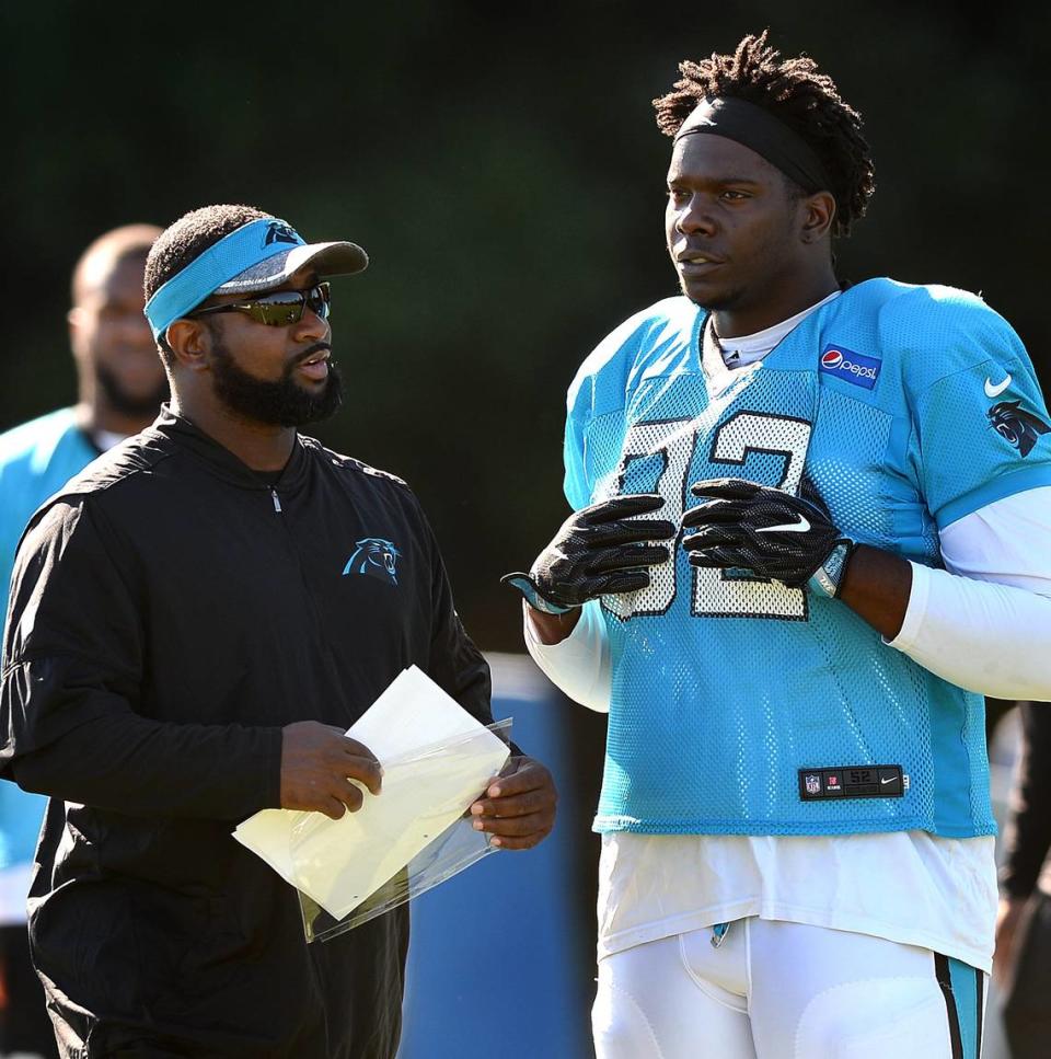 Carolina Panthers assistant defensive line coach Sam Mills III, left, talks with defensive tackle Vernon Butler, right, during practice in 2017.