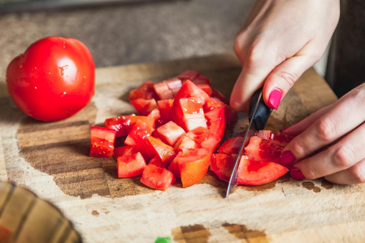 Tomato being diced into small cubes