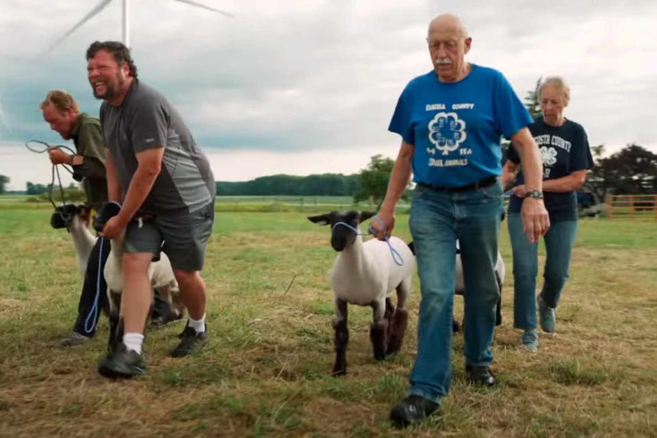 <p>Nat Geo WILD/YouTube</p> Charles Pol (front left) and Dr. Jan Pol (front right) handling sheep on The Incredible Pol Farm
