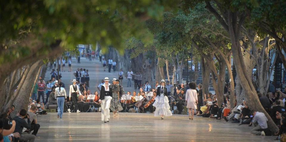 <p>Then came the actual Chanel cruises show, staged down a promenade with live musicians. Models sauntered up and down in white ruffled skirts, boater hats, Riviera style wide-leg trousers and everything else you would need for the chicest holiday wardrobe. </p>