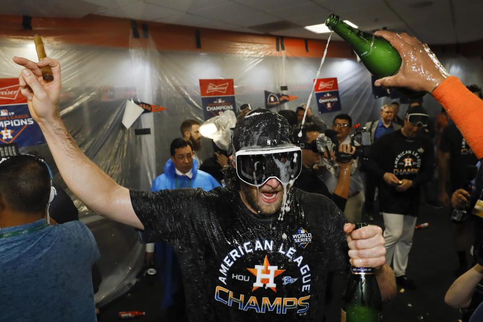 Houston Astros starting pitcher Gerrit Cole celebrates in the locker room after Game 6 of baseball's American League Championship Series against the New York Yankees Sunday, Oct. 20, 2019, in Houston. The Astros won 6-4 to win the series 4-2. (AP Photo/Matt Slocum)