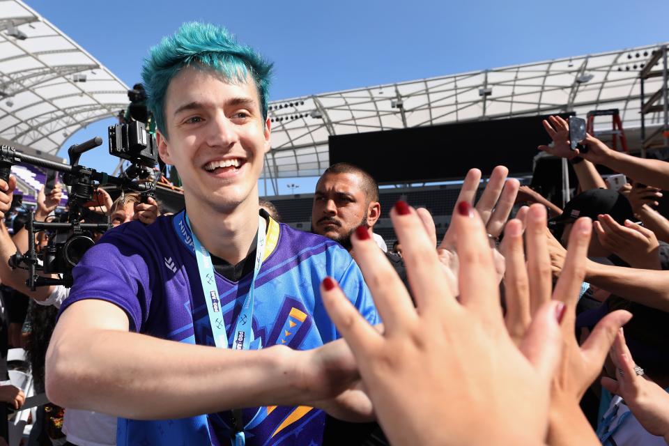  A gamer called Ninja high fives fans as he arrives to the Epic Games Fortnite E3 Tournament.