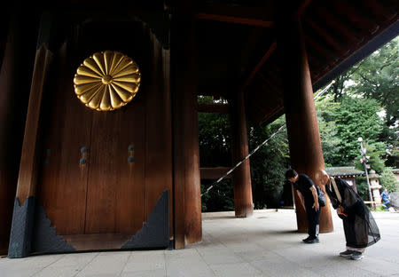 Visitors bow while paying tribute to the war dead at Yasukuni Shrine in Tokyo, Japan August 15, 2017, on the 72nd anniversary of Japan's surrender in World War Two. REUTERS/Issei Kato