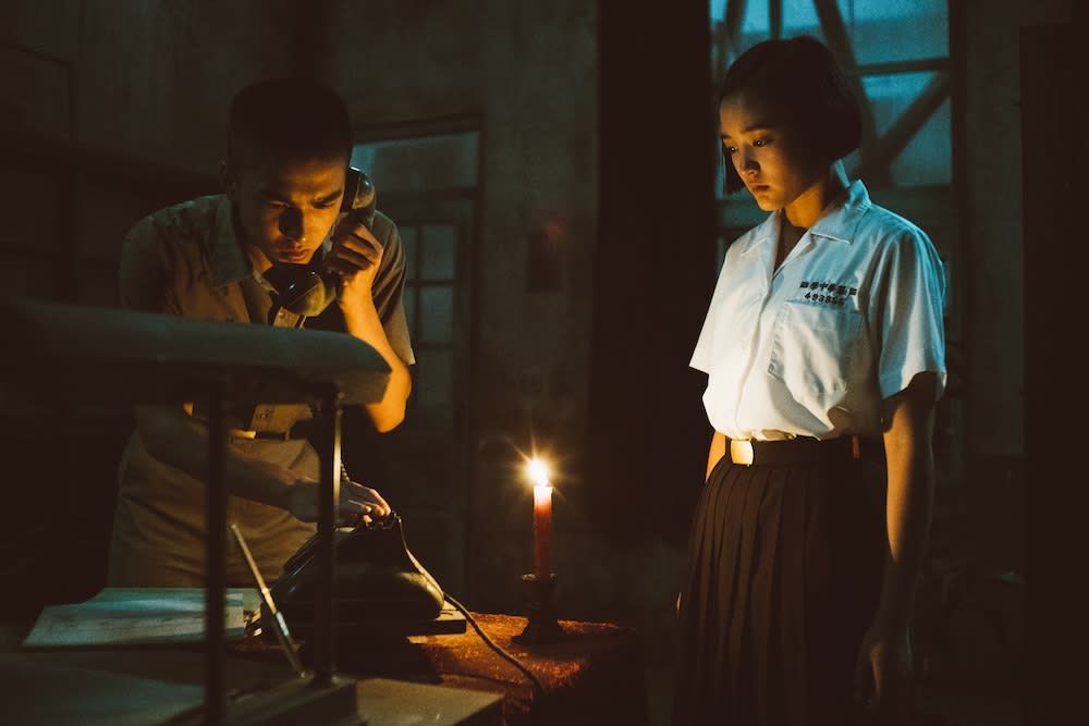 Wei Chung Ting (Tseng Ching-hua) answers the phone as Fang Ray Shin (Gingle Wang) watches on in Detention. (PHOTO: Encore Films)