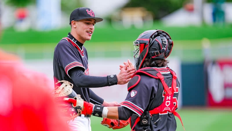 Utah pitcher Micah Ashman gives his catcher five during game against UCLA at Smith’s Ballpark in Salt Lake City on Saturday, April 27, 2024.