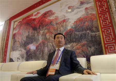 Wang Jianlin, chairman of Chinese property developer Dalian Wanda Group, sits in a meeting room as he arrives for the launch ceremony for the Qingdao Oriental Movie Metropolis on the outskirts of Qingdao, Shandong province September 22, 2013. REUTERS/Jason Lee