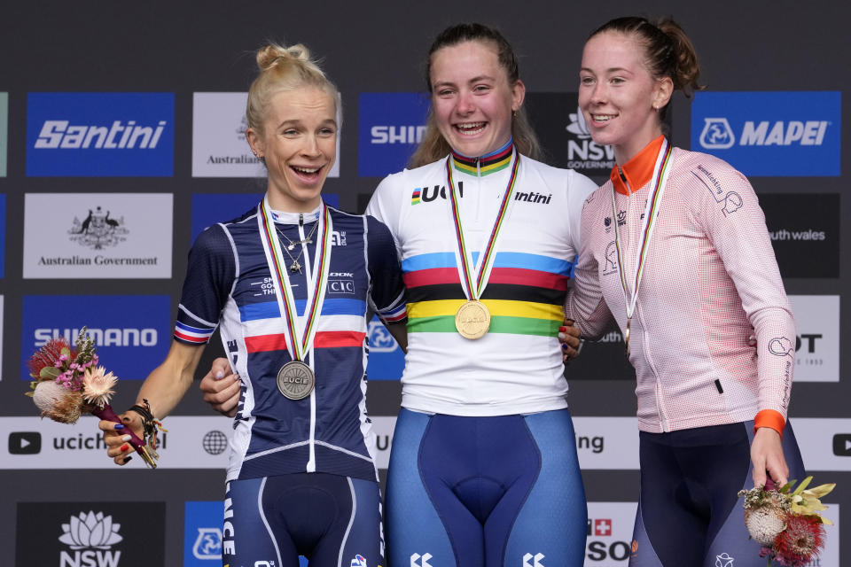 Britain's Zoe Backstedt, center, celebrates with the other medal winners, Eglantine Rayer of France, left, and Nienke Vinke of Netherlands from the junior women's road race at the world road cycling championships in Wollongong, Australia, Saturday, Sept. 24, 2022. Backstedt won gold, Rayer silver, and Vinke took the bronze. (AP Photo/Rick Rycroft)