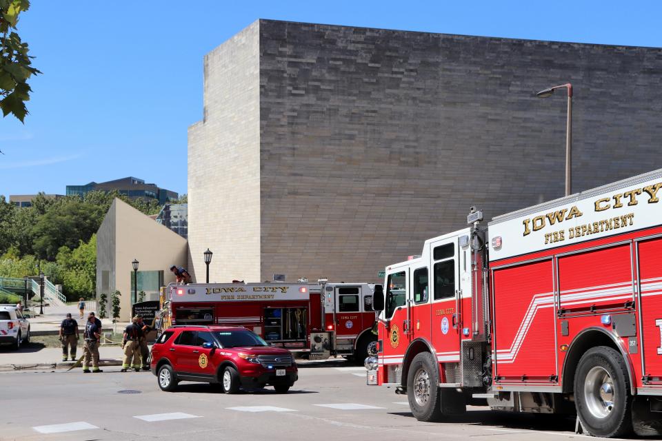 Emergency vehicles from departments across the area lined Madison Street as firefighters fought to extinguish a small fire that damaged the Iowa Advanced Technology Laboratories on Thursday, Aug. 31, 2023.