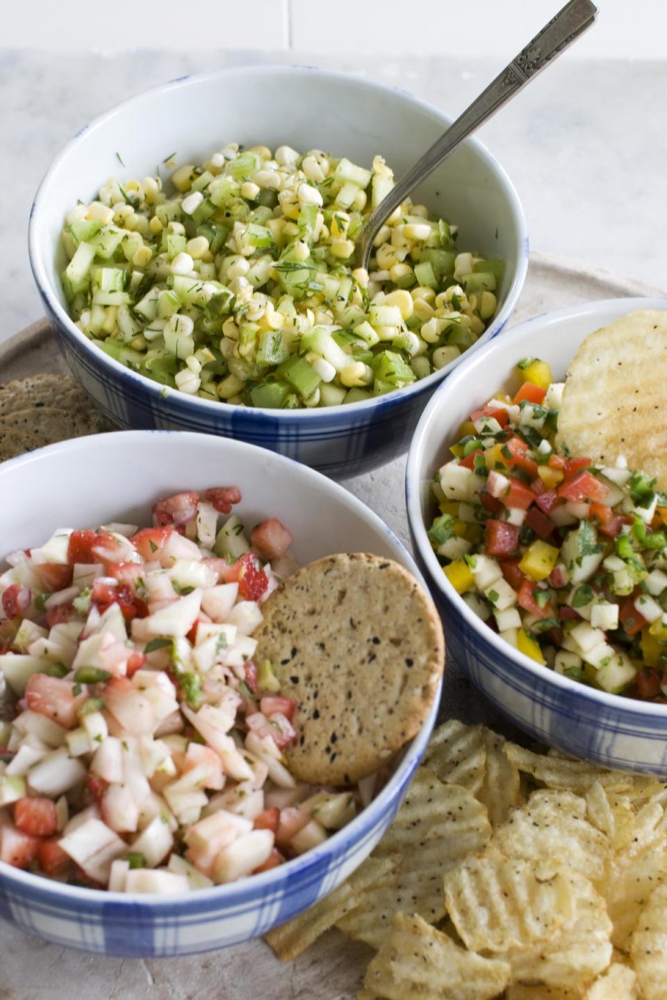 In this image taken on June 3, 2013, from top clockwise, cucumber-corn salsa, apple-pepper salsa and strawberry-fennel salsa are shown served in bowls in Concord, N.H. (AP Photo/Matthew Mead)